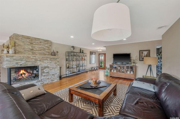 Fireplace, Interior, Living room, Recessed Lighting, Stone Walls, Wood Texture Flooring