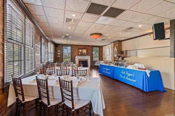 Dining room, Fireplace, Interior, Recessed Lighting, Stone Walls, Wood Texture Flooring