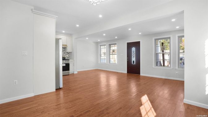 Empty room, Interior, Kitchen, Recessed Lighting, Stainless Steel Appliances, Wood Texture Flooring
