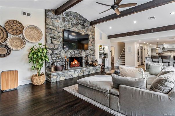 Fireplace, Interior, Kitchen, Living room, Pendant Lights, Recessed Lighting, Stainless Steel Appliances, Stone Walls, Wooden Beams, Wood Texture Flooring