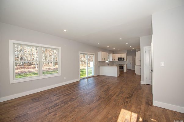 Empty room, Interior, Kitchen, Recessed Lighting, Stainless Steel Appliances, Wood Texture Flooring