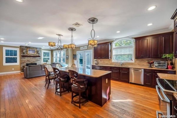 Dining room, Fireplace, Interior, Kitchen, Living room, Pendant Lights, Recessed Lighting, Stainless Steel Appliances, Stone Walls, Wood Texture Flooring