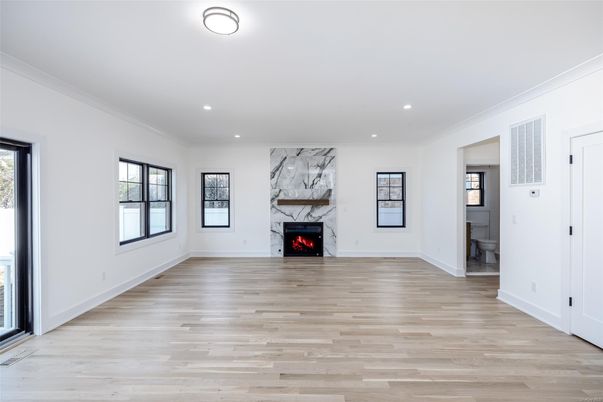 Empty room, Fireplace, Interior, Marble Walls, Recessed Lighting, Wood Texture Flooring