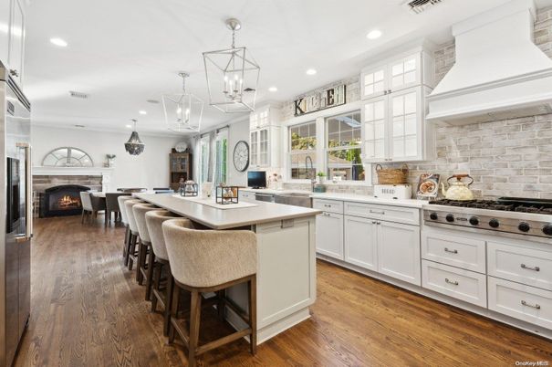 Dining room, Fireplace, Interior, Kitchen, Pendant Lights, Recessed Lighting, Stainless Steel Appliances, Stone Walls, Wood Texture Flooring