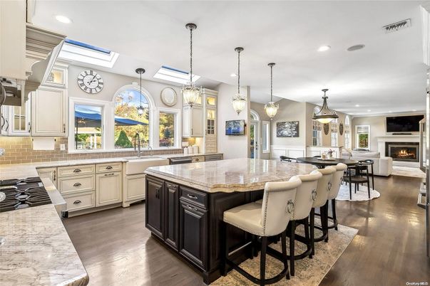 Chandelier, Dining room, Fireplace, Interior, Kitchen, Living room, Pendant Lights, Recessed Lighting, Stainless Steel Appliances, Wood Texture Flooring
