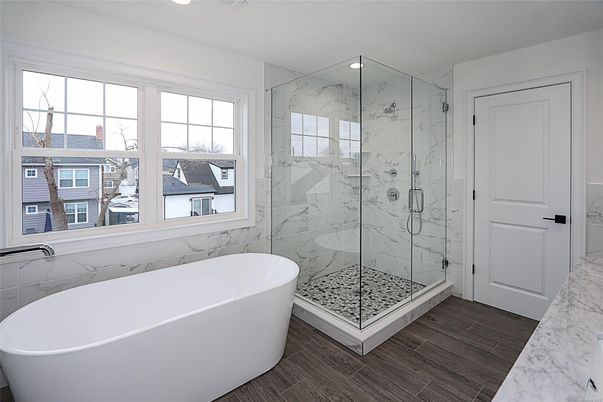 Bathroom, Free Standing Baths, Glass Shower, Interior, Marble Walls, Recessed Lighting, Wood Texture Flooring