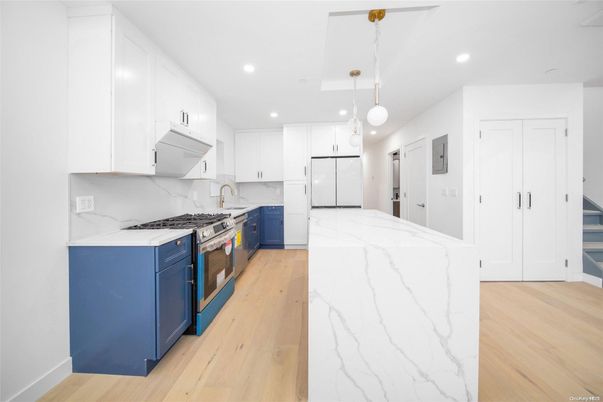Interior, Kitchen, Marble Walls, Pendant Lights, Recessed Lighting, Stainless Steel Appliances, Wood Texture Flooring