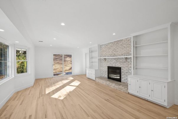 Empty room, Fireplace, Interior, Recessed Lighting, Stone Walls, Wood Texture Flooring