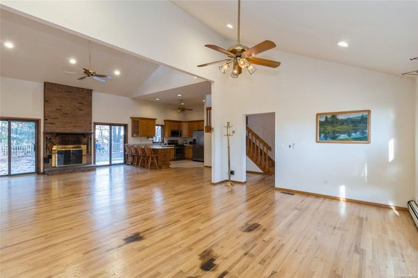 Empty room, Fireplace, Interior, Kitchen, Recessed Lighting, Stone Walls, Wood Texture Flooring