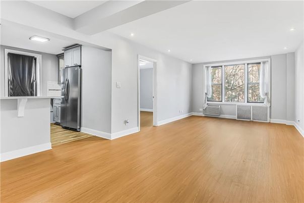 Empty room, Interior, Kitchen, Recessed Lighting, Stainless Steel Appliances, Wood Texture Flooring