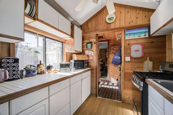Interior, Kitchen, Tile Countertops, Wood Texture Flooring, Wooden Walls