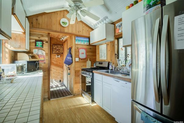 Interior, Kitchen, Tile Countertops, Wood Texture Flooring, Wooden Walls