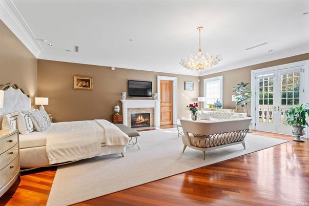 Bedroom, Chandelier, Fireplace, Interior, Recessed Lighting, Wood Texture Flooring