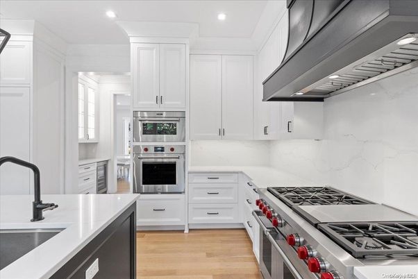 Interior, Kitchen, Marble Walls, Recessed Lighting, Stainless Steel Appliances, Wood Texture Flooring