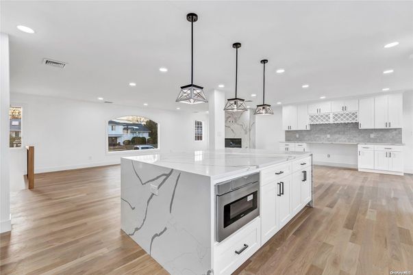 Interior, Kitchen, Marble Walls, Pendant Lights, Recessed Lighting, Stainless Steel Appliances, Wood Texture Flooring