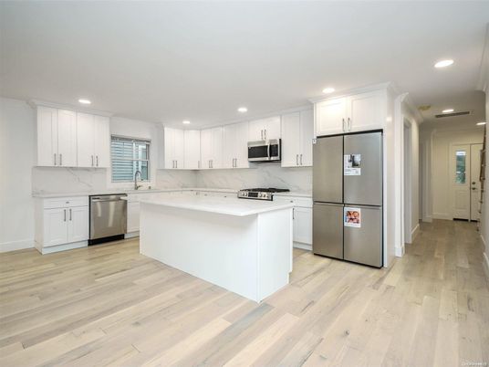 Interior, Kitchen, Marble Walls, Recessed Lighting, Stainless Steel Appliances, Wood Texture Flooring