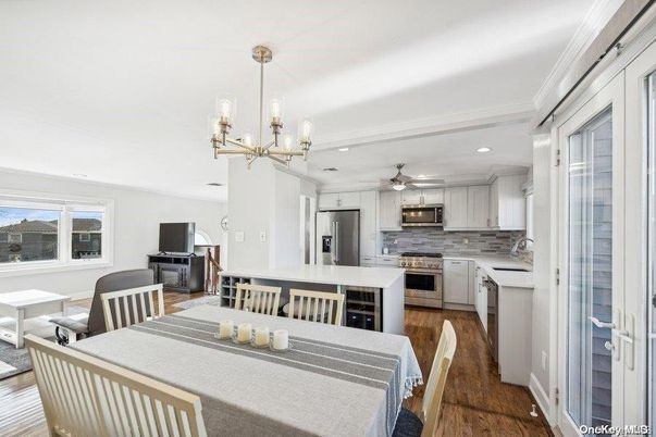 Chandelier, Dining room, Interior, Kitchen, Recessed Lighting, Stainless Steel Appliances, Wood Texture Flooring