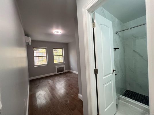 Bathroom, Glass Shower, Interior, Marble Walls, Wood Texture Flooring