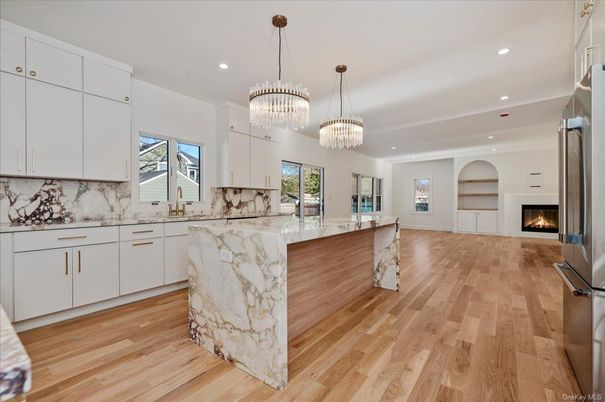 Chandelier, Fireplace, Interior, Kitchen, Marble Walls, Recessed Lighting, Wood Texture Flooring
