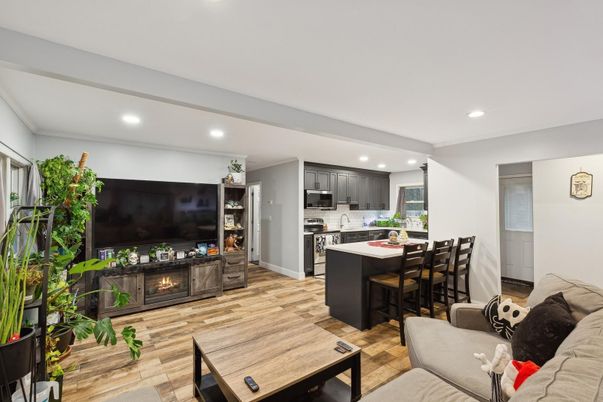 Dining room, Fireplace, Interior, Kitchen, Living room, Recessed Lighting, Stainless Steel Appliances, Wood Texture Flooring
