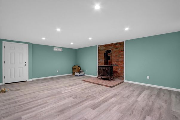 Empty room, Fireplace, Interior, Recessed Lighting, Stone Walls, Wood Texture Flooring