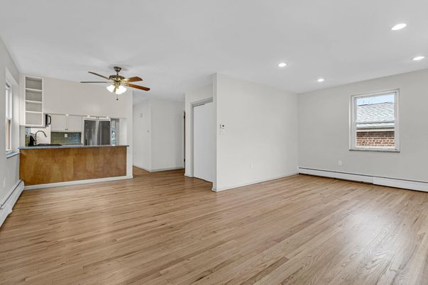 Empty room, Interior, Kitchen, Recessed Lighting, Stainless Steel Appliances, Wood Texture Flooring