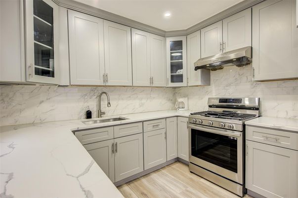 Interior, Kitchen, Marble Walls, Recessed Lighting, Stainless Steel Appliances, Wood Texture Flooring