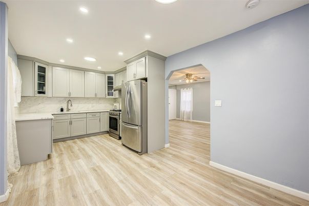 Interior, Kitchen, Marble Walls, Recessed Lighting, Stainless Steel Appliances, Wood Texture Flooring