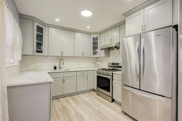 Interior, Kitchen, Marble Walls, Recessed Lighting, Stainless Steel Appliances, Wood Texture Flooring