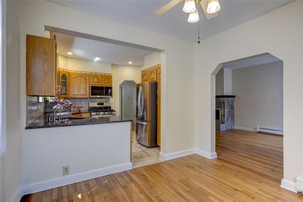 Fireplace, Interior, Kitchen, Recessed Lighting, Stainless Steel Appliances, Wood Texture Flooring