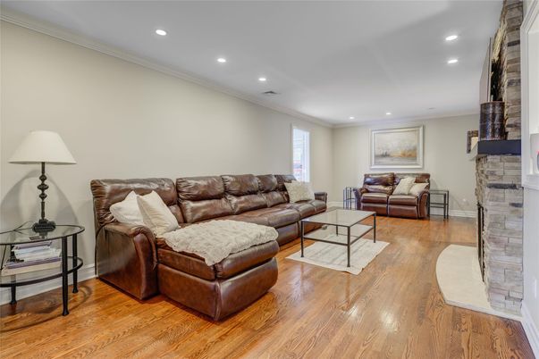 Fireplace, Interior, Living room, Recessed Lighting, Stone Walls, Wood Texture Flooring