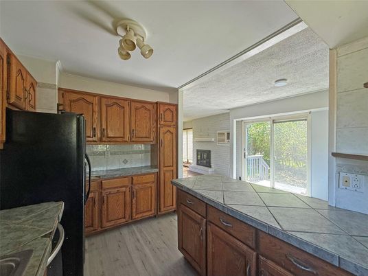 Fireplace, Interior, Kitchen, Tile Countertops, Wood Texture Flooring