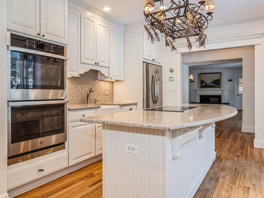 Chandelier, Fireplace, Interior, Kitchen, Recessed Lighting, Stainless Steel Appliances, Wood Texture Flooring