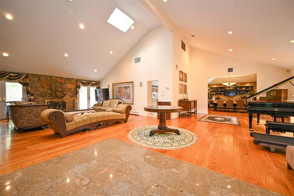 Fireplace, Interior, Living room, Piano, Recessed Lighting, Stone Walls, Wood Texture Flooring