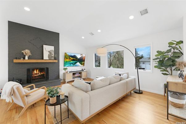 Fireplace, Interior, Living room, Recessed Lighting, Stone Walls, Wood Texture Flooring