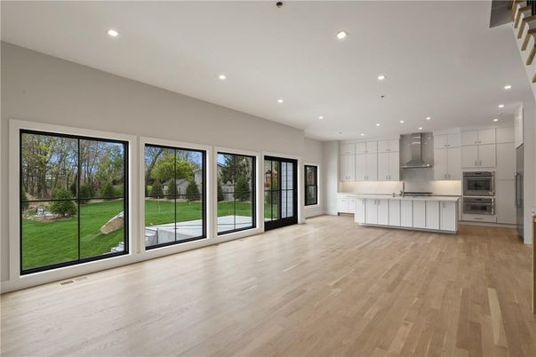Empty room, Interior, Kitchen, Recessed Lighting, Stainless Steel Appliances, Wood Texture Flooring