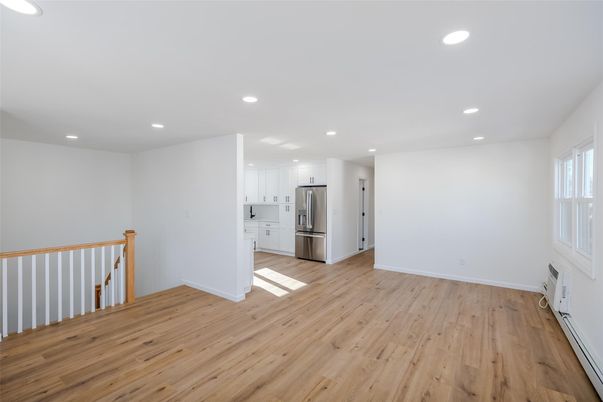 Empty room, Interior, Kitchen, Recessed Lighting, Stainless Steel Appliances, Wood Texture Flooring