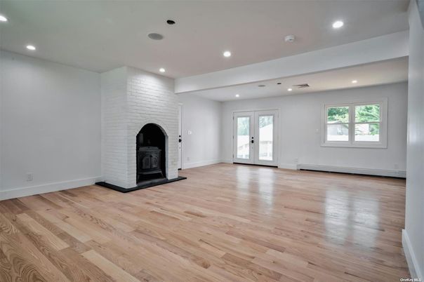 Empty room, Fireplace, Interior, Recessed Lighting, Stone Walls, Wood Texture Flooring