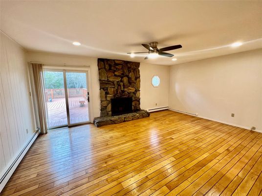 Empty room, Fireplace, Interior, Recessed Lighting, Stone Walls, Wood Texture Flooring