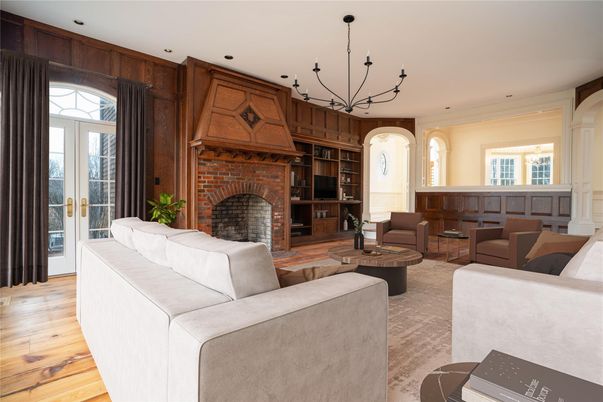Chandelier, Fireplace, Interior, Living room, Recessed Lighting, Stone Walls, Wood Texture Flooring