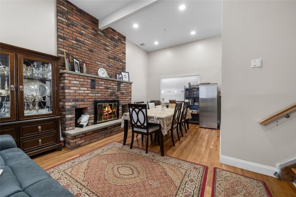 Dining room, Fireplace, Interior, Recessed Lighting, Stone Walls, Wood Texture Flooring