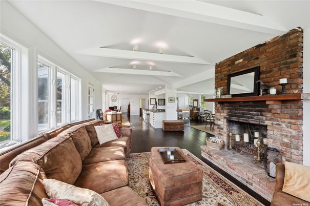Dining room, Fireplace, Interior, Living room, Recessed Lighting, Stone Walls, Wood Texture Flooring