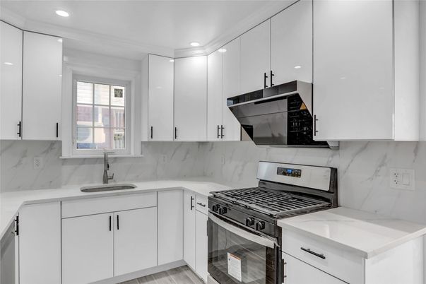 Interior, Kitchen, Marble Walls, Recessed Lighting, Stainless Steel Appliances, Wood Texture Flooring