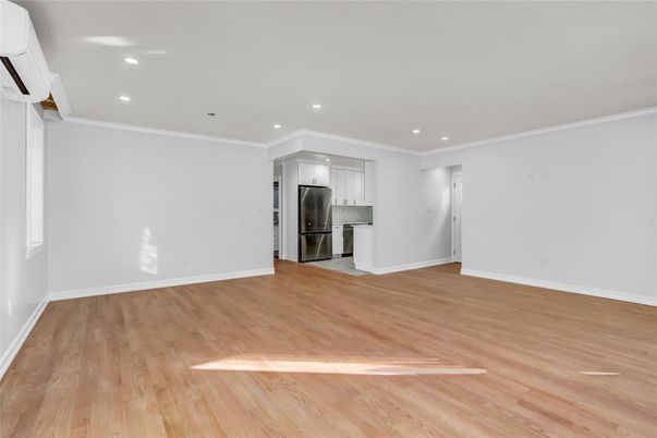 Empty room, Interior, Kitchen, Recessed Lighting, Stainless Steel Appliances, Wood Texture Flooring
