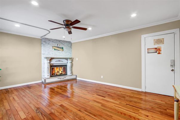 Empty room, Fireplace, Interior, Recessed Lighting, Stone Walls, Wood Texture Flooring