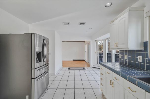 Interior, Kitchen, Recessed Lighting, Tile Countertops, Wood Texture Flooring
