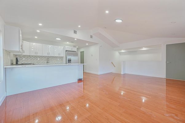 Empty room, Interior, Kitchen, Recessed Lighting, Stainless Steel Appliances, Wood Texture Flooring