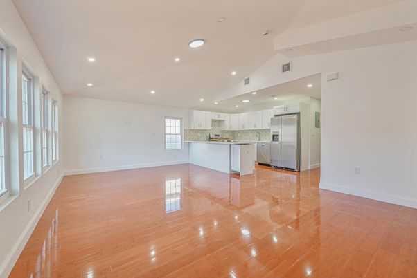 Empty room, Interior, Kitchen, Recessed Lighting, Stainless Steel Appliances, Wood Texture Flooring