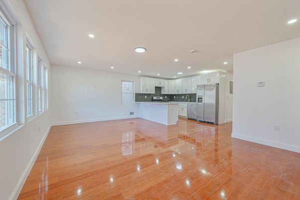 Empty room, Interior, Kitchen, Recessed Lighting, Stainless Steel Appliances, Wood Texture Flooring