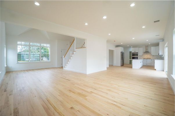 Empty room, Interior, Kitchen, Recessed Lighting, Stainless Steel Appliances, Wood Texture Flooring